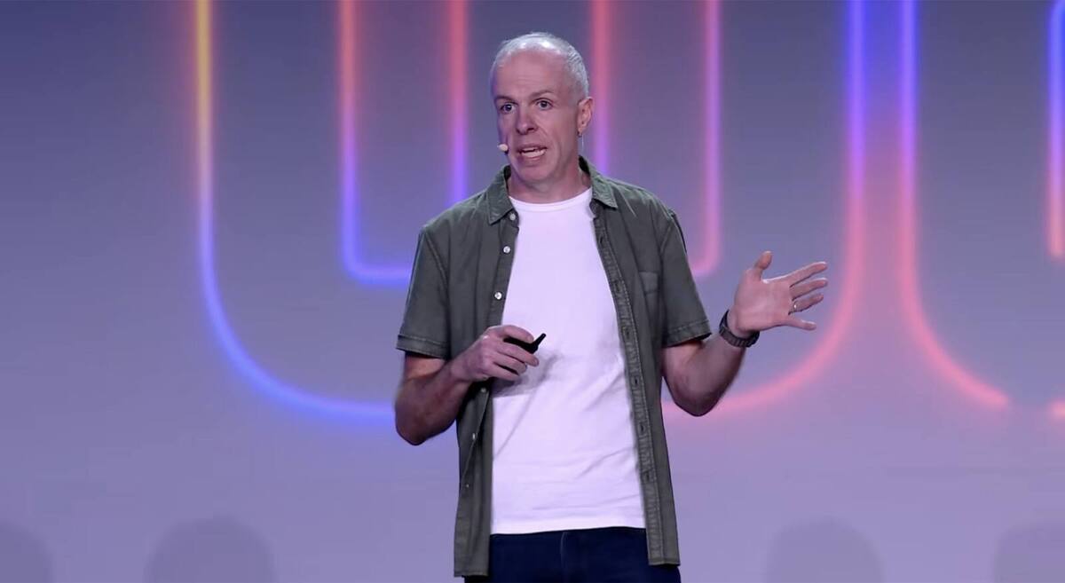 Ryan Sherlock on stage at Rails World 2026, in front of a glowing neon backdrop