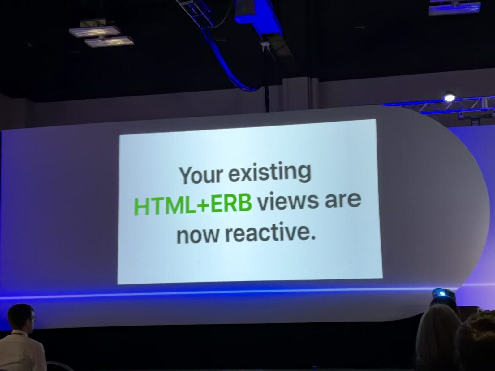 A slide reading 'Your existing HTML+ERB views are now reactive,' with HTML+ERB highlighted in green